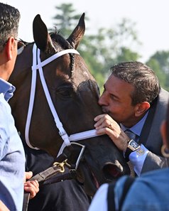 Mike Repole kisses Fierceness after his win in the 2024 Jim Dandy Stakes at Saratoga Race Course