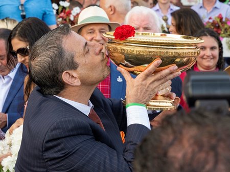 Owner Mike Repole kissing the Travers trophy after Fierceness' victory