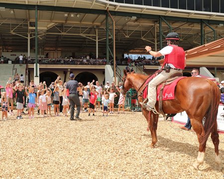 Young fans play 'Simon Says' in the Ellis Park winner's circle