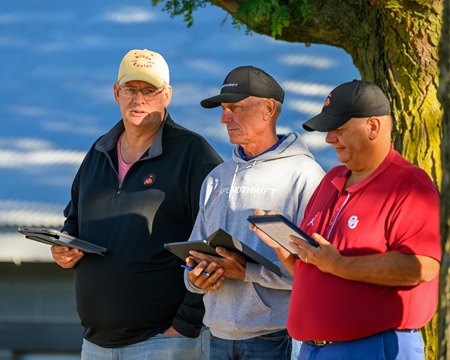 Ned Toffey (left) and other Spendthrift representatives examine yearlings at the Keeneland September Yearling Sale