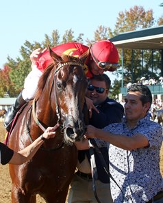 Trainer Matthew Sims gives Luan Machado a hug after Brunacini's victory in the Perryville Stakes at Keeneland