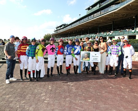 Jockeys celebrate Paco Lopez's 4,000th career win aboard Governor Sam in the Indian Summer Stakes at Keeneland
