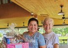 Michelle Borisenok, right, with member of the backstretch community Maria Lopes