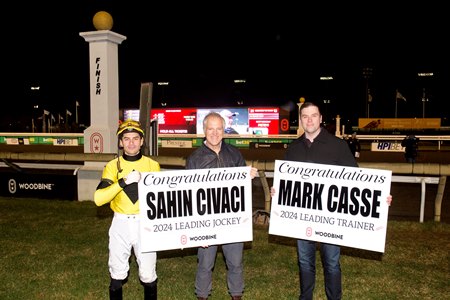 Woodbine's Bill Ford (center) and Mark McKelvie (right) present meet leader awards to jockey Sahin Civaci (left) and Mark Casse