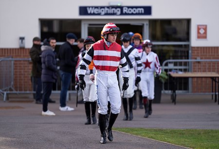 Jockeys exit a weighing room