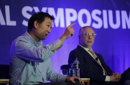 (L-R): Dr. Marshall Gramm and Matt Feig speak during a panel at the Global Symposium on Racing