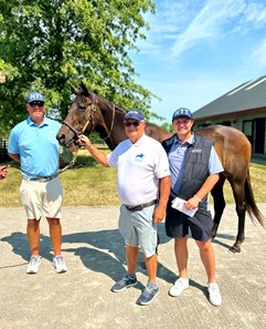 Dennis Albaugh (center) holding Miss Macy Sue