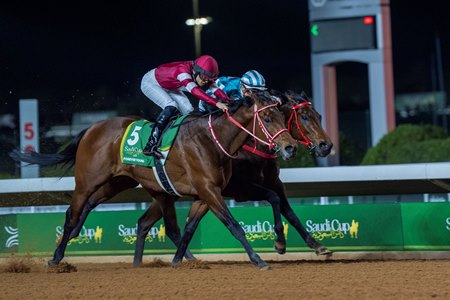 Forever Young (outside) runs down Romantic Warrior to win the Saudi Cup at King Abdulaziz Racecourse