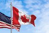 Canada and US national flags waving in the wind on a clear day. North America Countries. 3D illustration render. Rippled fabric. Selective focus Rippled fabric. Selective focus