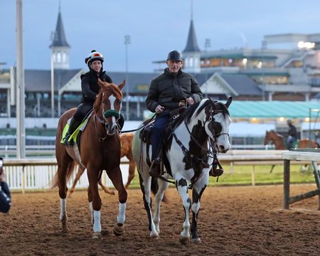 D. Wayne Lukas, atop his pony, accompanies American Promise as the colt exits the track after morning training at Churchill Downs