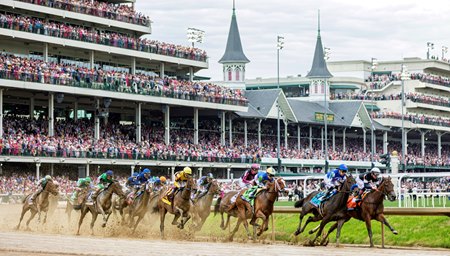 The field for the Kentucky Oaks races around the clubhouse turn at Churchill Downs