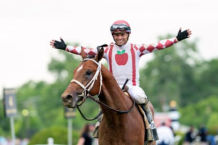 Jockey Umberto Rispoli celebrates Journalism's victory in the Preakness Stakes at Pimlico Race Course