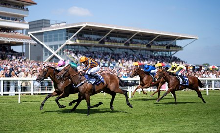 Lead Artist (pink cap) defeats Dancing Gemini to win the Lockinge Stakes at Newbury Racecourse
