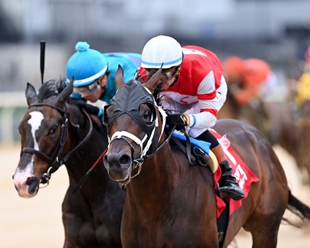 Bishops Bay (white cap) wins the Westchester Stakes at Aqueduct Racetrack