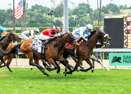Atitlan (light blue cap) wins the Charles Whittingham Stakes at Santa Anita Park