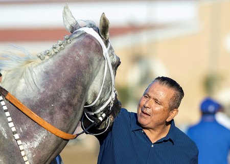 Trainer Librado Barocio celebrates with Lovesick Blues after the Bing Crosby Stakes July 26 at Del Mar