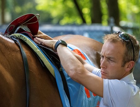 Trainer Joe Sharp saddles a horse in the Saratoga Race Course paddock