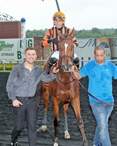 Nick Vaccarezza (left) leads Golden Afternoon into the winner's circle after the Tom Ridge Stakes at Presque Isle Downs