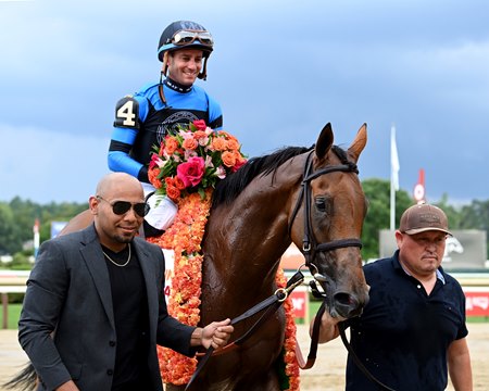 Excellent Truth and Flavien Prat head into the winner's circle after winning the Diana Stakes at Saratoga Race Course