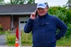 Kenny McPeek on the phone and smiliing as he crosses the street to his barn. 
Training scenes from Saratoga Racecourse on Aug. 21, 2025.