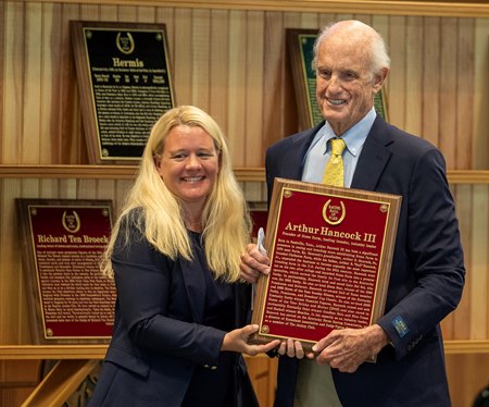 Arthur Hancock III is inducted into the Racing Hall of Fame in 2025; Hall director Cate Masterson hands him the plaque