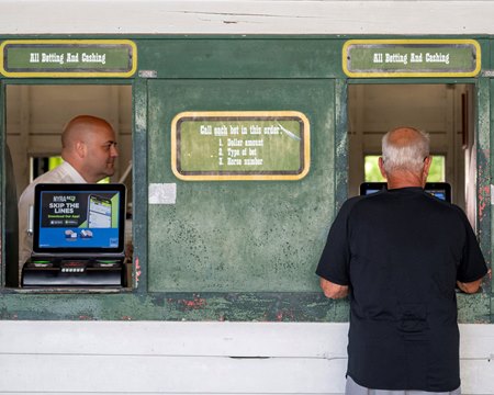 A horseplayer keys in bets at Saratoga Race Course