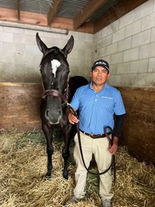 Mauro Lucas with Hip 2597, a filly by Girvin, at the Keeneland September Sale