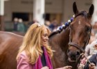 Anna's Co-Owner and breeder, Judy Hicks, and a groom for Kenny McPeek walk Thorpedo Anna in the paddock at Churchill Downs.