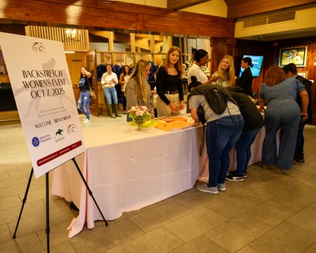 Women signing up for screenings and healthcare at the Backstretch Women’s Appreciation Event at Keeneland 