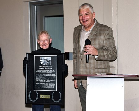 Jockey Perry Ouzts is honored in December 2025 at Turfway Park, with Chip Bach presenting