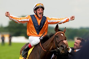 Andrasch Starke celebrates aboard Danedream after their victory in the 2012 King George VI and Queen Elizabeth Stakes at Ascot Racecourse