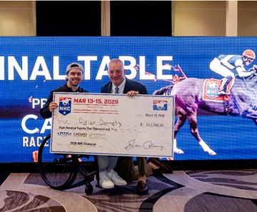Dylan Donnelly (left) receives a ceremonial check for $825,000 from the NTRA's Tom Rooney after winning the National Horseplayers Championship