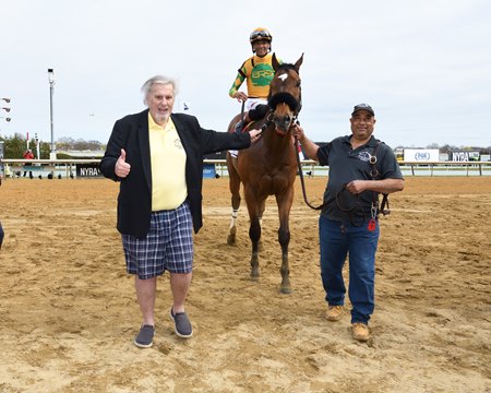 Bryan Bushey (left) leads Point Dume into the winner's circle after the Carter Stakes at Aqueduct Racetrack