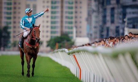 James McDonald celebrates aboard Romantic Warrior after their win in the 2024 Queen Elizabeth II Cup at Sha Tin Racecourse