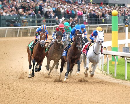 Horse of the Year Sovereignty (middle, blue cap) leads White Abarrio (rail) and Journalism (far outside) into the clubhouse turn during the Oaklawn Handicap at Oaklawn Park