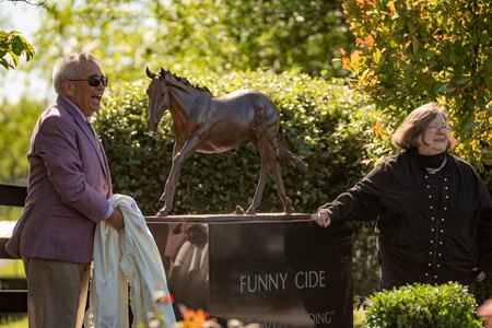 Jack Knowlton removes the blanket to unveil the Funny Cide statue April 30 at the Kentucky Horse Park