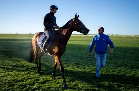 Abashiri, under Billy Loughnane, walks alongside trainer Charlie Appleby at Newmarket Racecourse