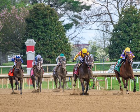 Eclatant (outside) rallies to win the Madison Stakes at Keeneland