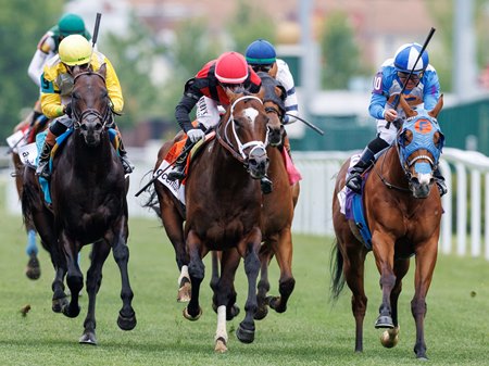 Yellow Card (center) with jockey Flavien Prat wins the Twin Spires Turf Sprint Stakes at Churchill Downs