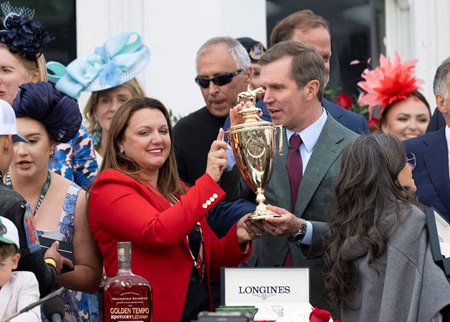 Kentucky Derby-winning trainer Cherie DeVaux in the winner's circle with Kentucky Gov. Andy Beshear, who acknowledged her accomplishment as the first woman to win the Derby as a trainer