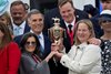 Co-owners Teresa Viola, left, and Daisy Phipps Pulito, right, with Vincent Viola, upper left, and Ogden Phipps II, right, hold the trophy in the winner’s circle after winning the Kentucky Derby, presented by Woodford Reserve, (G1) with Golden Tempo and Jose Ortizat Churchill Downs in Louisville, Ky., on May 2, 2026.
