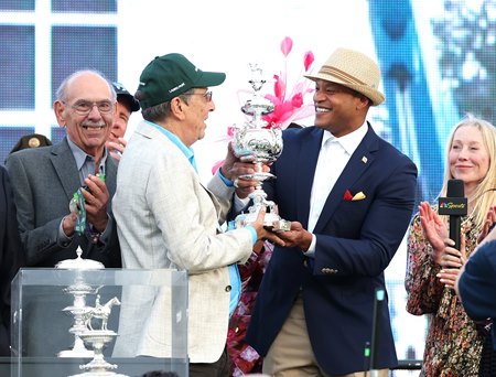 Owner Al Gold (left) accepts the trophy from Maryland Gov. Wes Moore in the Preakness Stakes winner's circle after Napoleon Solo's victory at Laurel Park