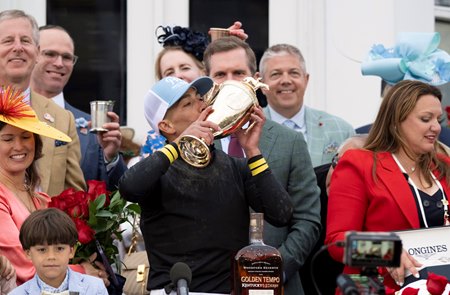 Jose Ortiz hoists the Kentucky Derby trophy after riding Golden Tempo to victory at Churchill Downs