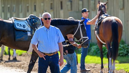 Todd Pletcher watches horses jog June 3 outside his barn at Saratoga Race Course