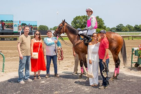 Unsolved Mystery and her connections in the winner's circle at Monmouth Park