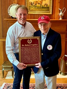 Gardner "G.D." Hieronymus (left) presents Dr. Robert Copelan his Racing Hall of Fame plaque as a 2026 Pillar of the Turf inductee