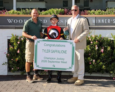 Tyler Gaffalione is presented with signage commemorating his leading rider title at Churchill Downs