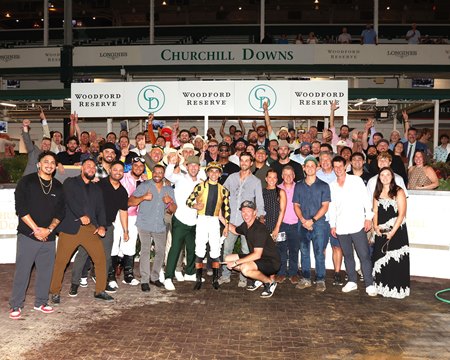 Players from the Chicago Cubs and other supporters surround jockey Axel Concepcion after Act of Parliament's victory at Churchill Downs