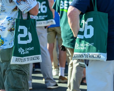 Racegoers sport commemorative tote bags, race-day giveaways on opening day at Belmont Park