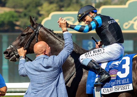 Jockey Mike Smith celebrates Cabo Spirit's City of Hope Mile win with trainer George Papaprodromou at Santa Anita Park